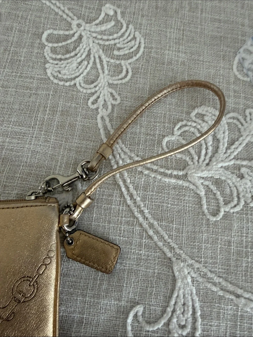 Coach Metallic Gold Wristlet with Embossed Chain Motif
